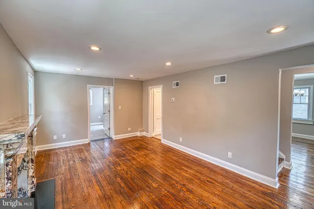 a view of a kitchen with stove and wooden floor