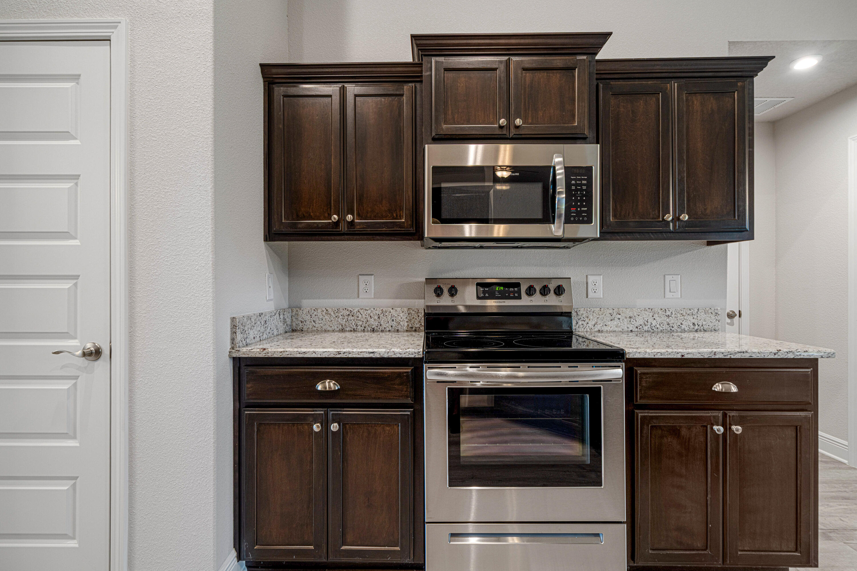 2004 Broad Street Crestview, FL 32536 - Photo 11 of 46 a kitchen with granite countertop a stove and a microwave