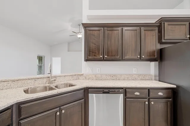 a utility room with a sink cabinets and utility