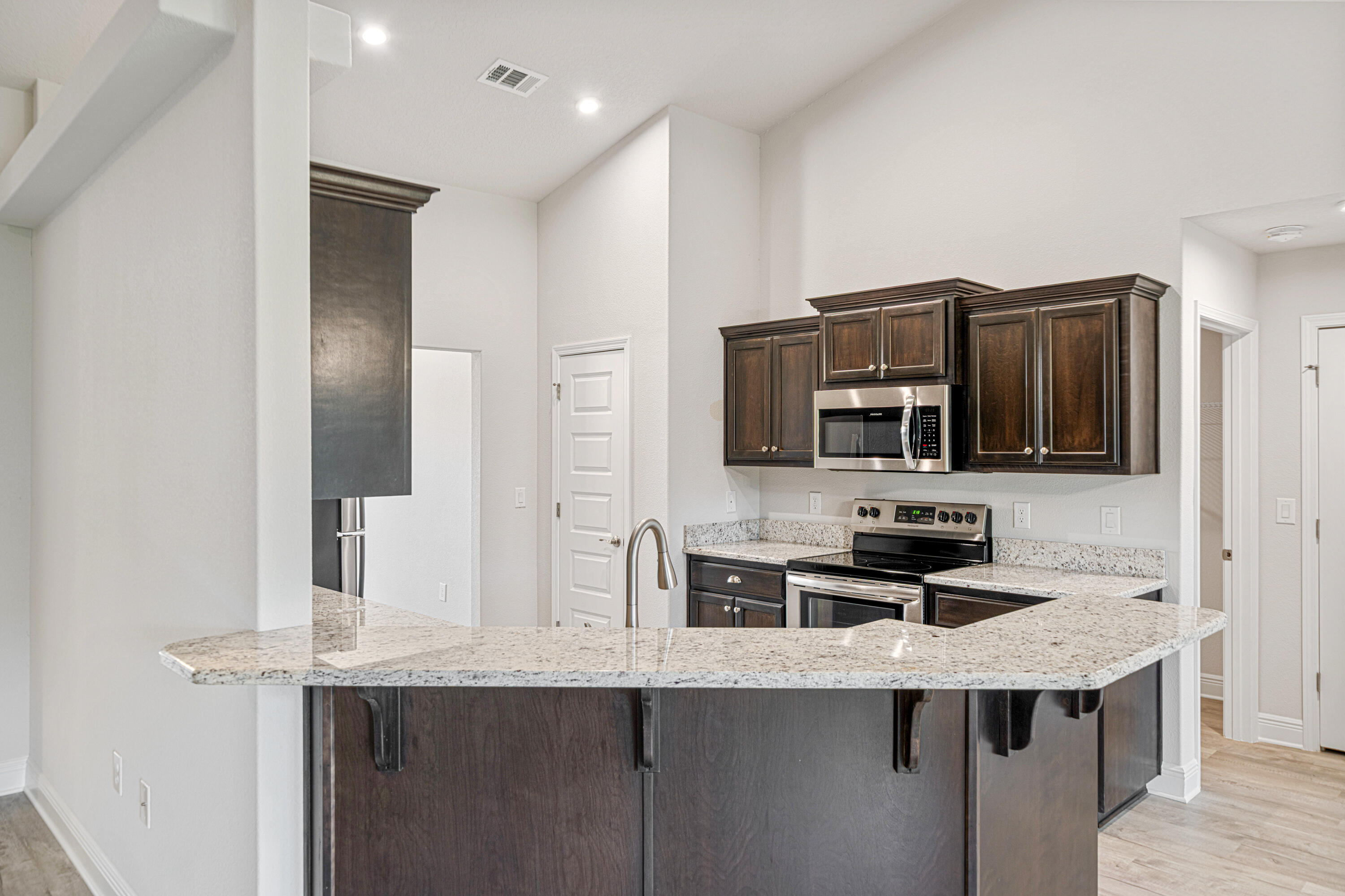 2004 Broad Street Crestview, FL 32536 - Photo 13 of 46 a kitchen with stainless steel appliances a stove refrigerator and microwave