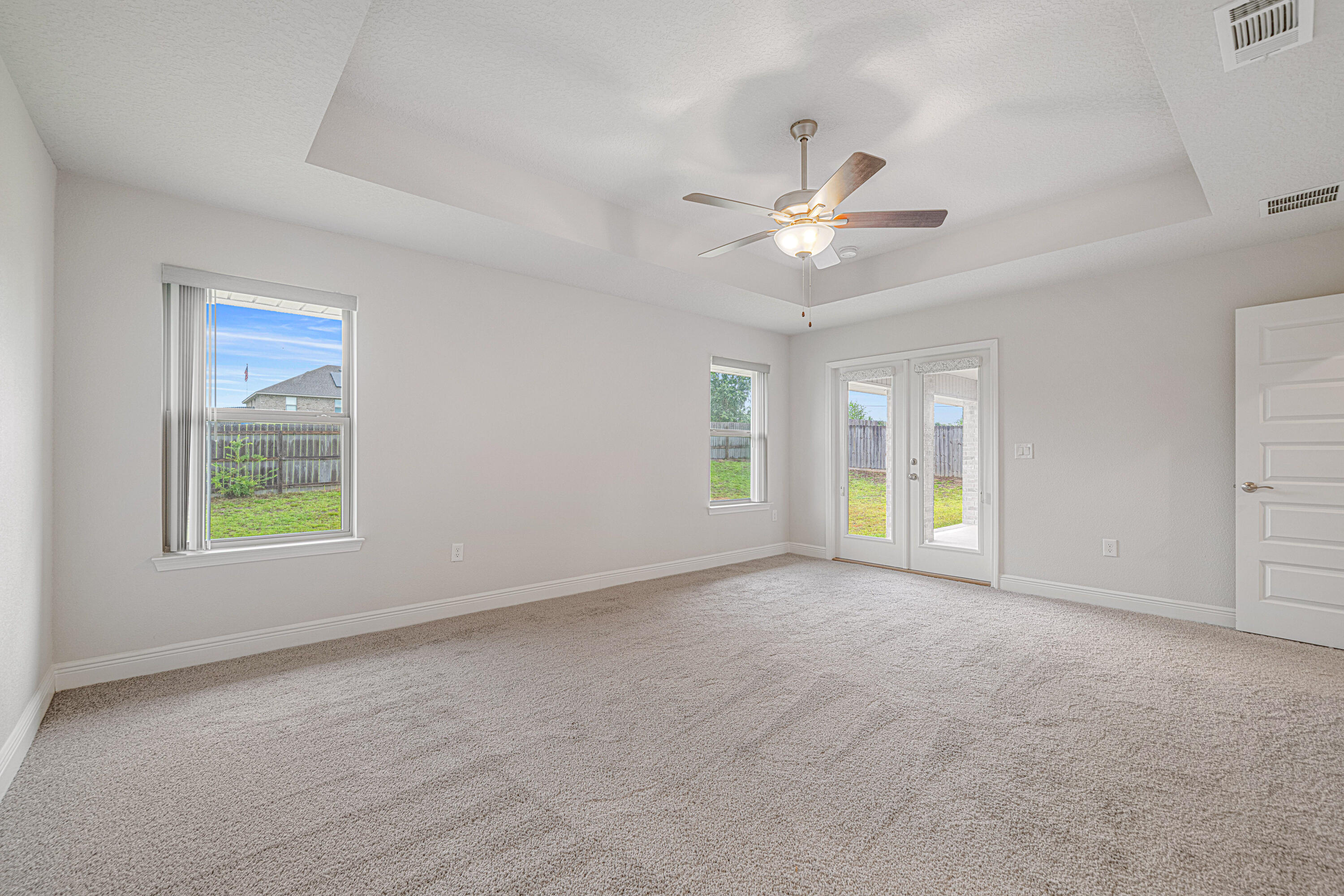 2004 Broad Street Crestview, FL 32536 - Photo 19 of 46 an empty room with windows and ceiling fan