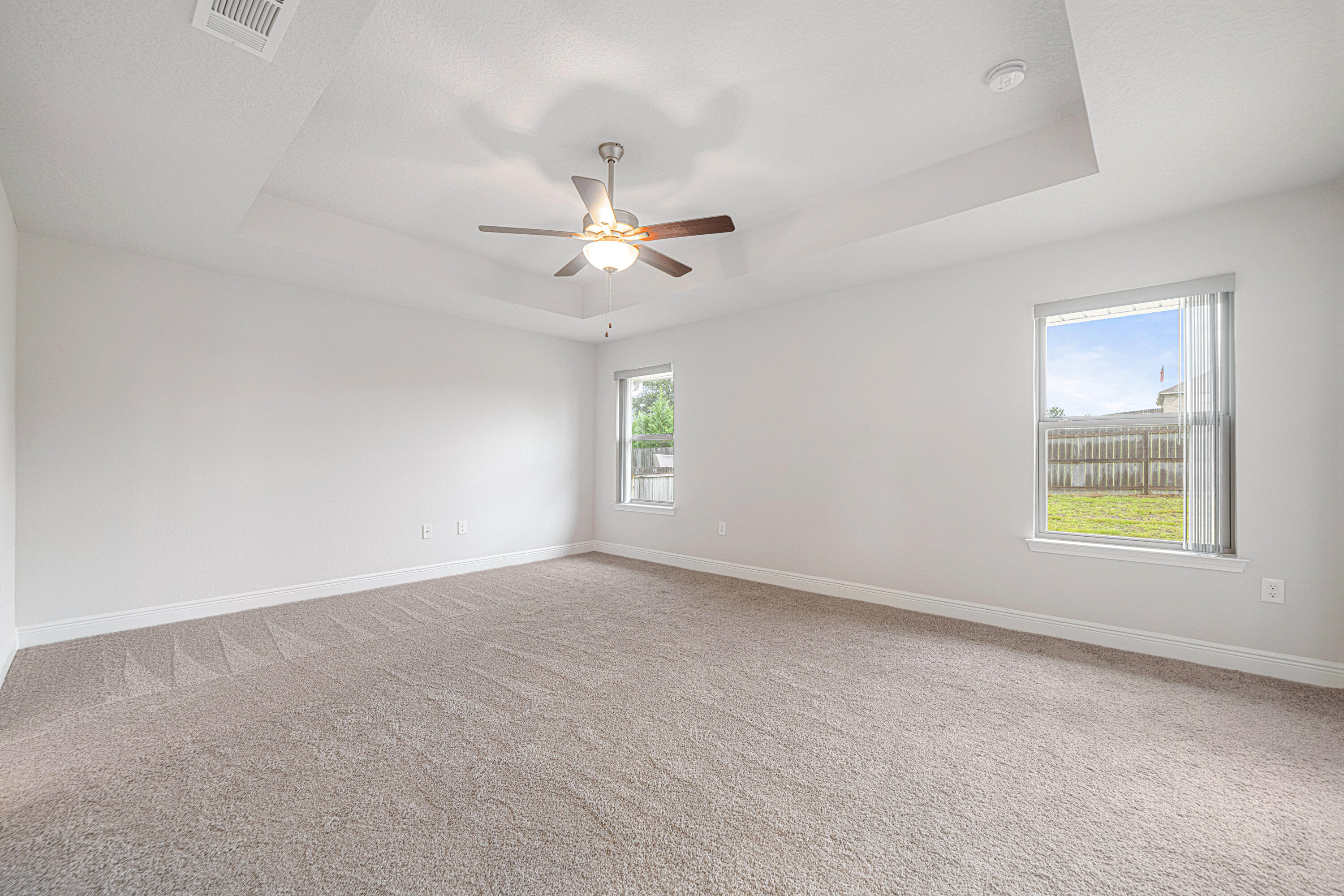 2004 Broad Street Crestview, FL 32536 - Photo 20 of 46 an empty room with windows and ceiling fan