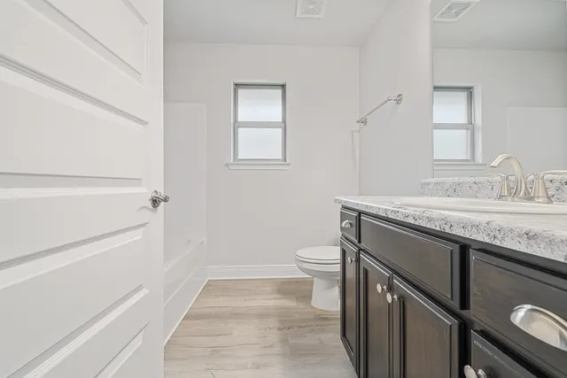 a bathroom with a granite countertop sink a large mirror and a vanity