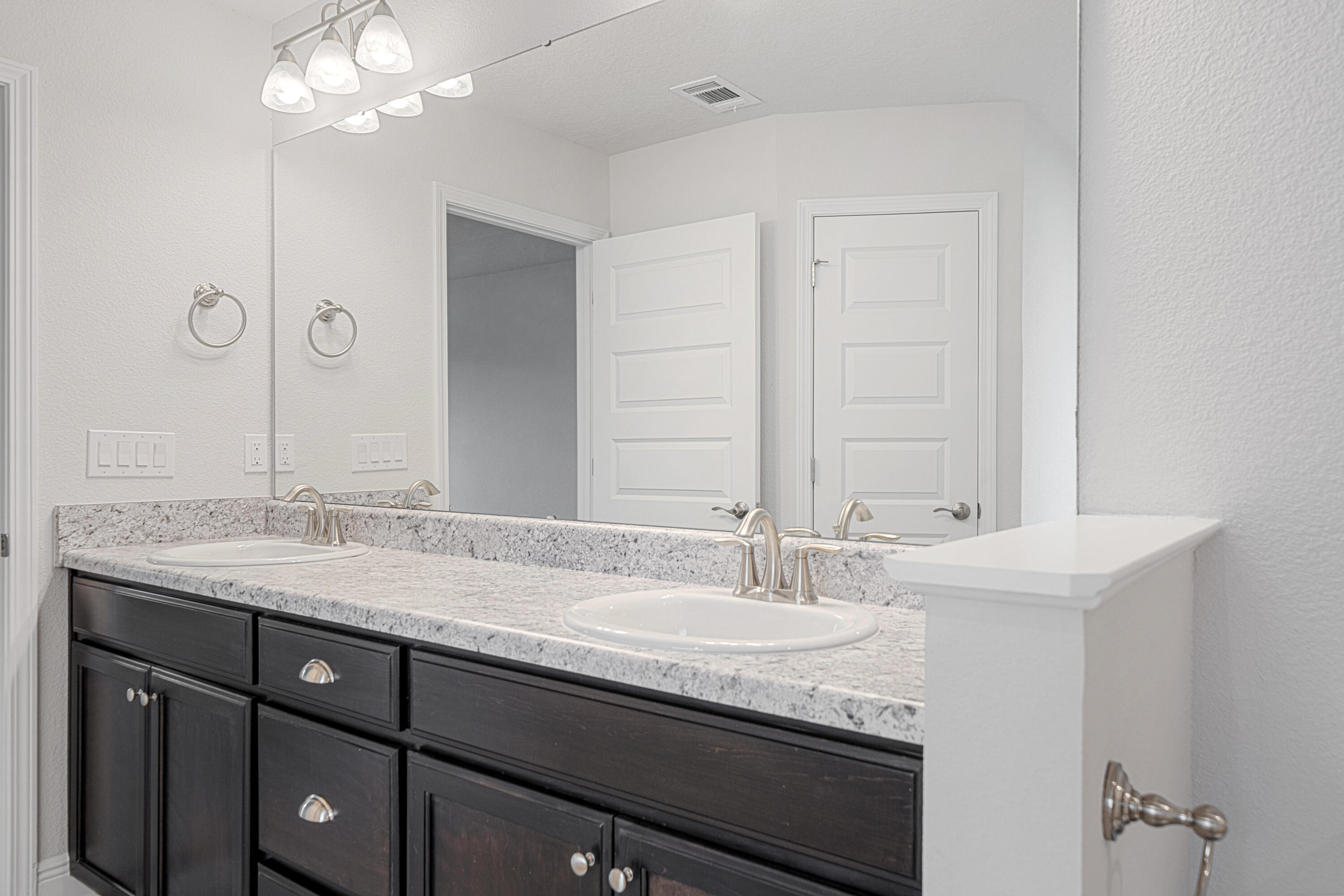 2004 Broad Street Crestview, FL 32536 - Photo 23 of 46 a bathroom with a granite countertop sink a large mirror and a vanity