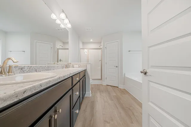 a bathroom with a granite countertop sink a toilet and bathtub
