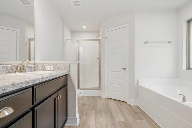 a view of a room with wooden floor and white walls