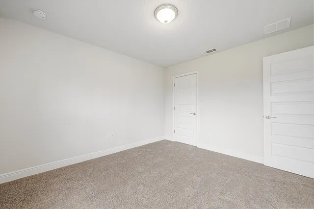 a bathroom with a granite countertop sink toilet and mirror
