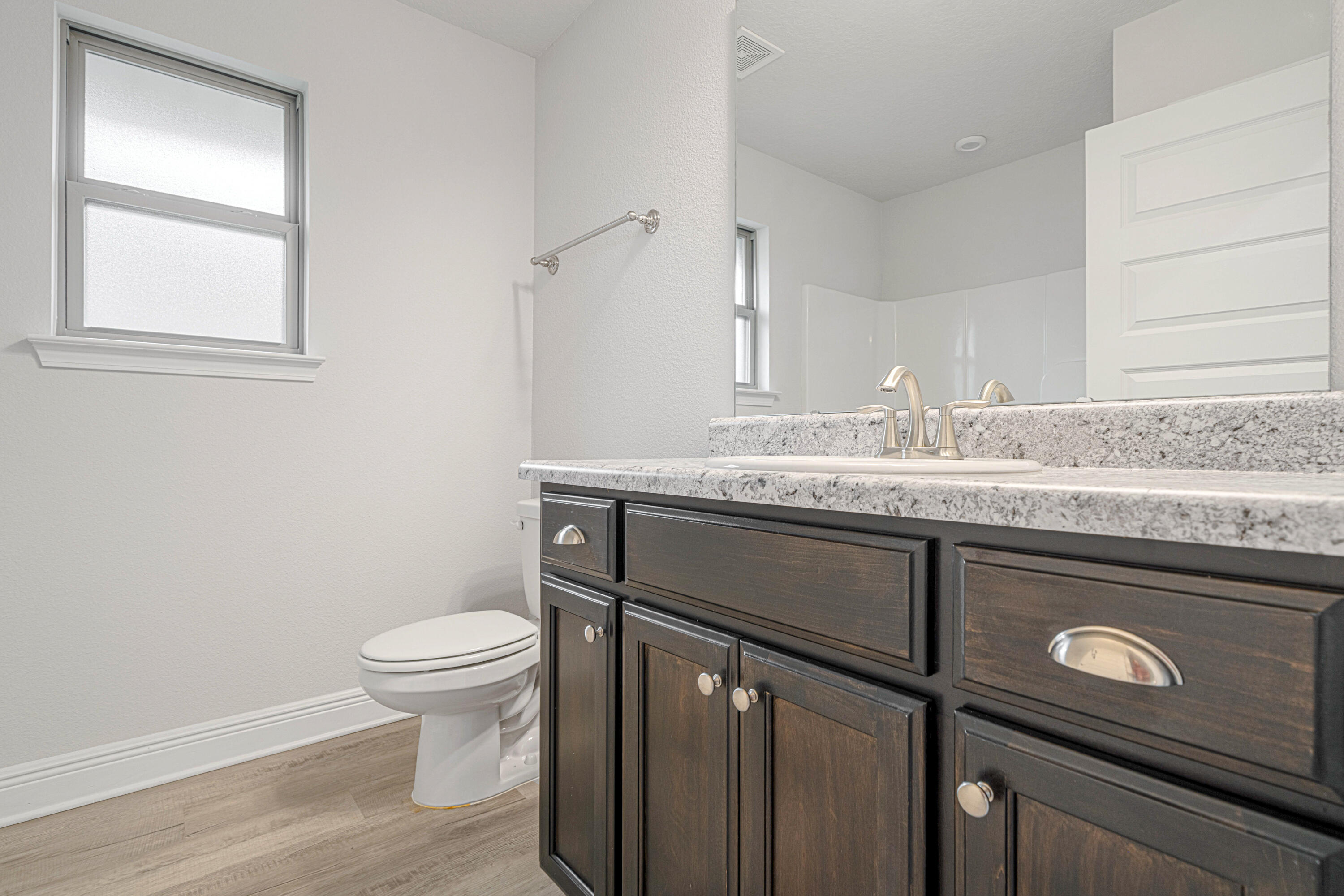 2004 Broad Street Crestview, FL 32536 - Photo 40 of 46 a bathroom with a granite countertop sink toilet and mirror