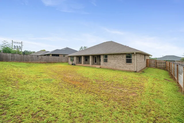 a view of a swimming pool and a yard