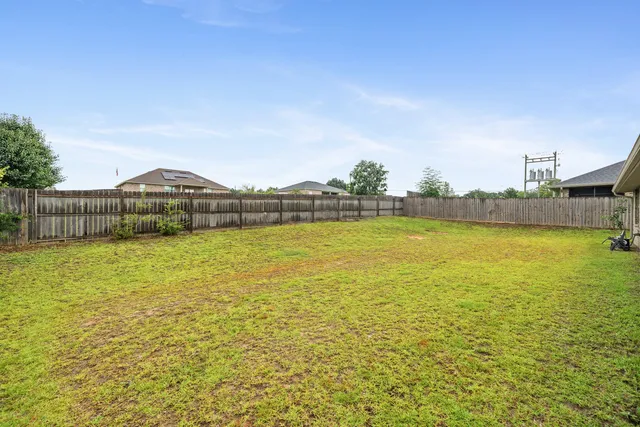 a view of a swimming pool with seating area and mountains in the background