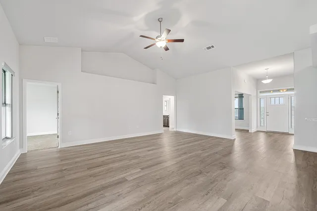 a view of an empty room with wooden floor