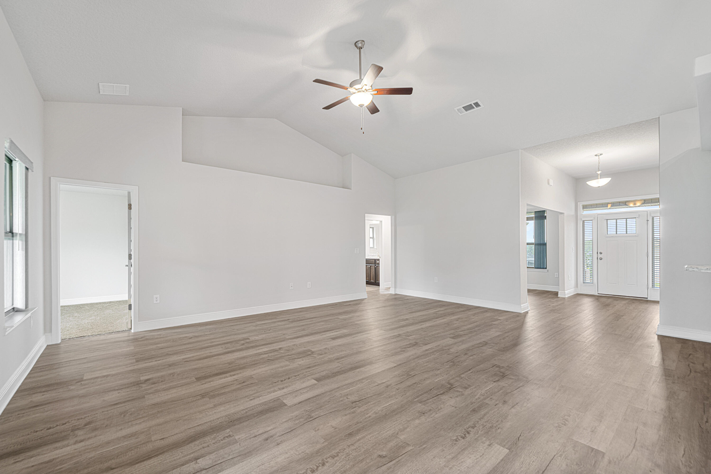 2004 Broad Street Crestview, FL 32536 - Photo 6 of 46 a view of an empty room with wooden floor