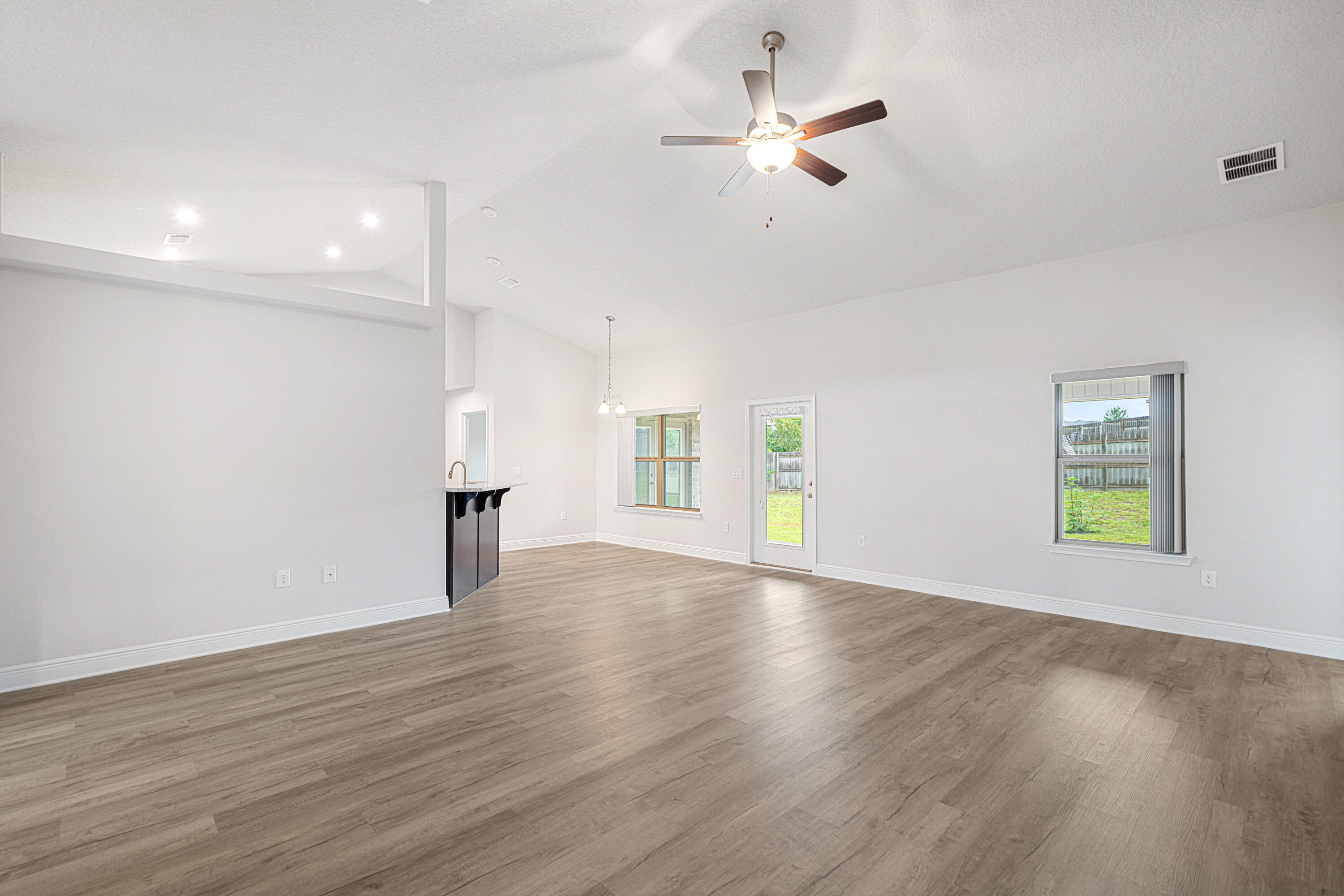 2004 Broad Street Crestview, FL 32536 - Photo 8 of 46 a view of an empty room with a window and wooden floor