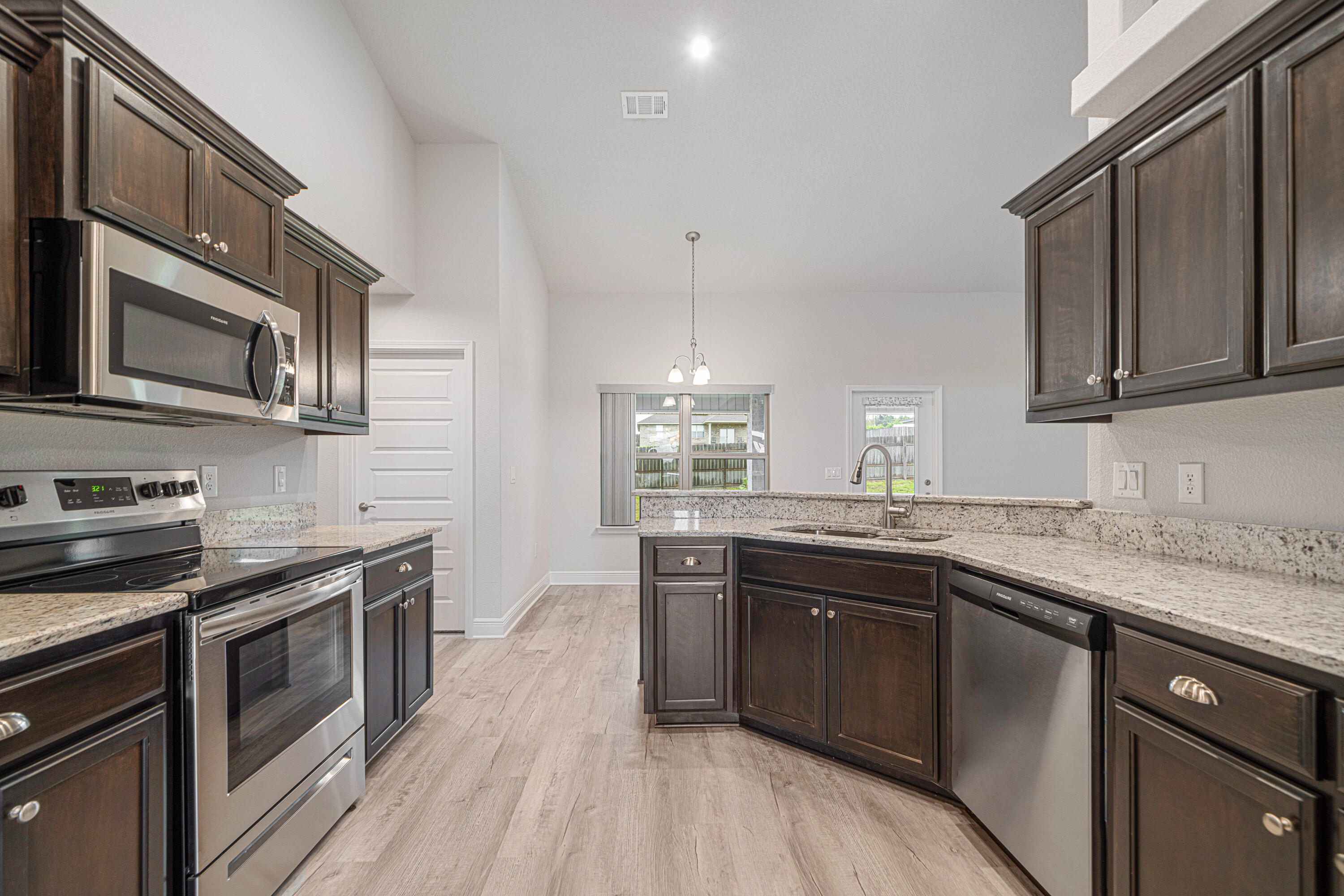 2004 Broad Street Crestview, FL 32536 - Photo 9 of 46 a kitchen with stainless steel appliances granite countertop a sink stove and oven