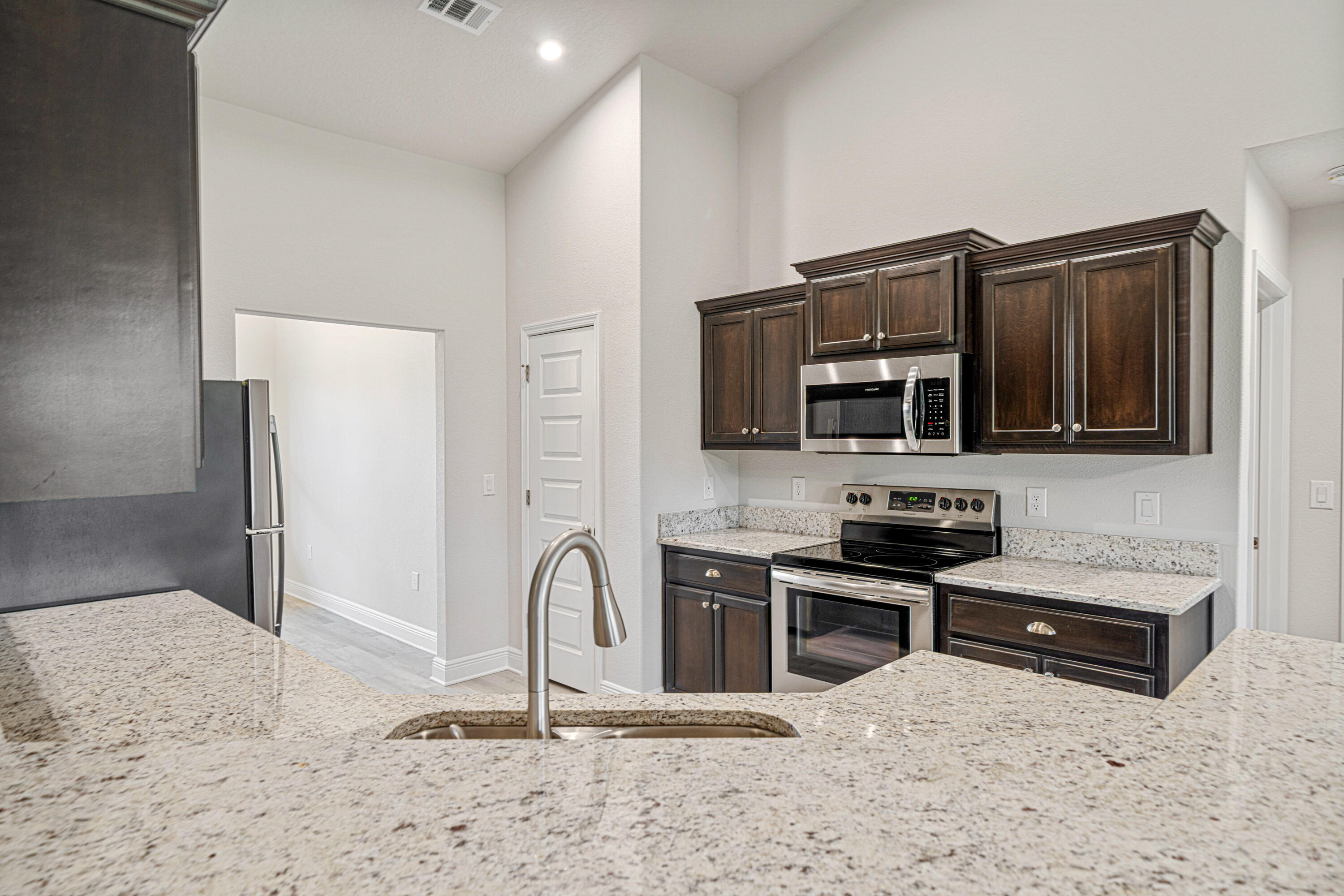 2004 Broad Street Crestview, FL 32536 - Photo 10 of 46 a kitchen with stainless steel appliances granite countertop a refrigerator and a stove top oven