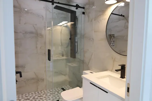 a bathroom with a sink toilet and shower