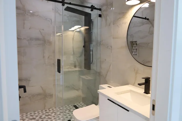 a bathroom with a sink toilet and shower