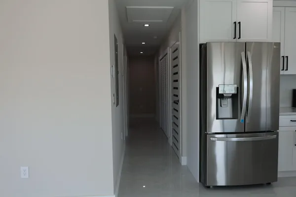 a metallic refrigerator freezer sitting in a kitchen