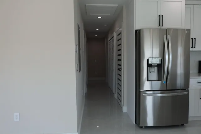 a metallic refrigerator freezer sitting in a kitchen