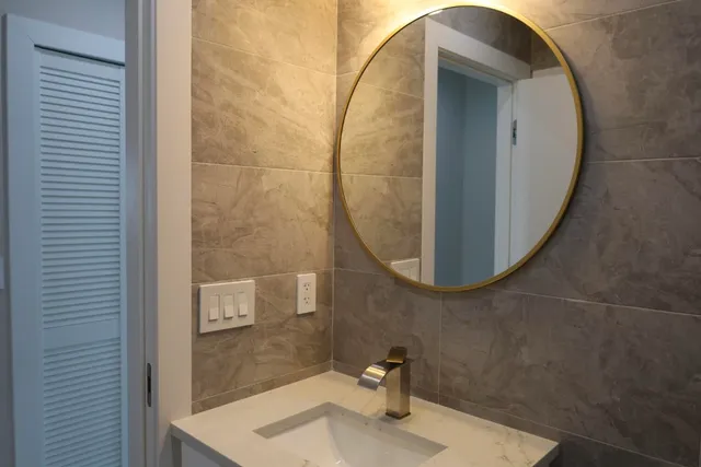 a bathroom with a sink and a mirror