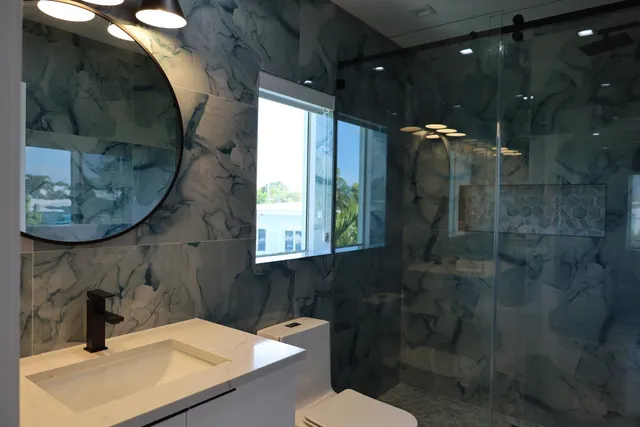 a bathroom with a sink toilet and shower