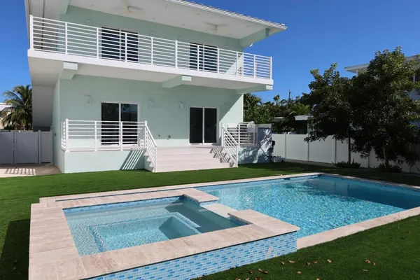 a view of a house with backyard and sitting area