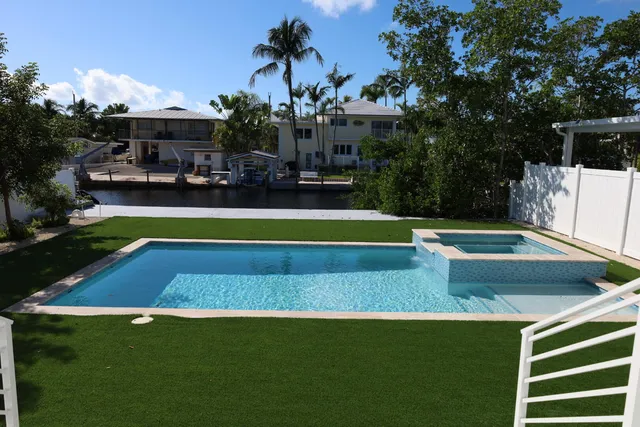 a view of swimming pool with chairs