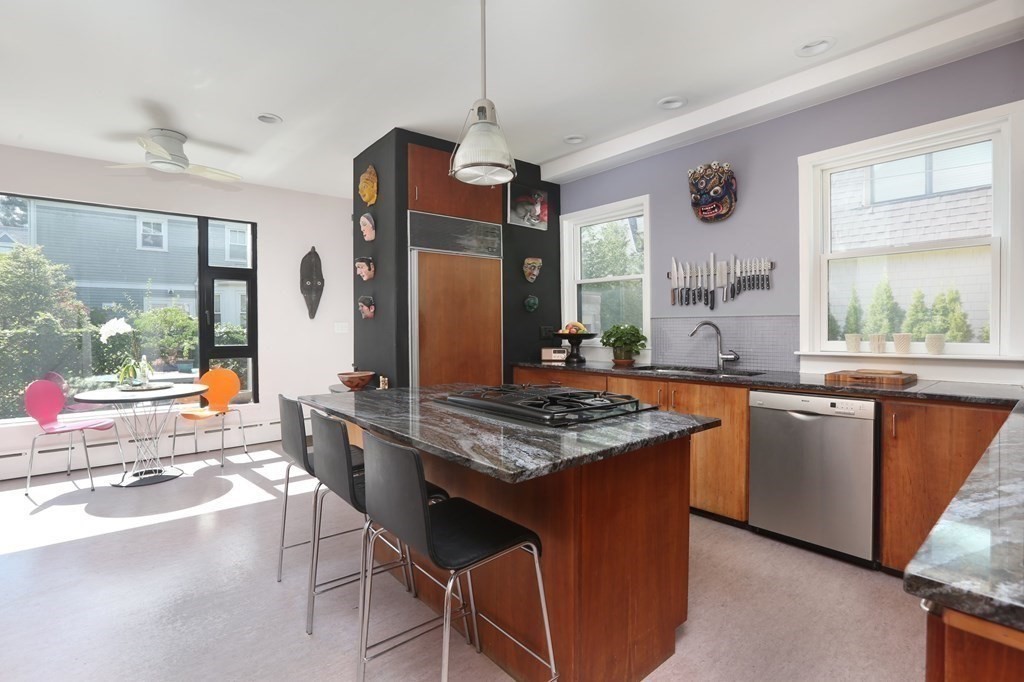 33 Thorndike Street Brookline, MA 02446 - Photo 5 of 13 a kitchen with stainless steel appliances granite countertop a stove a sink dishwasher and a refrigerator with wooden floor