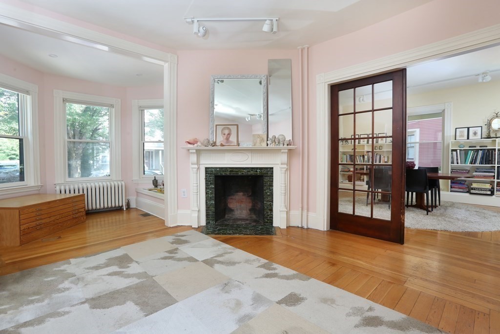 33 Thorndike Street Brookline, MA 02446 - Photo 6 of 13 a view of a livingroom with a fireplace and window