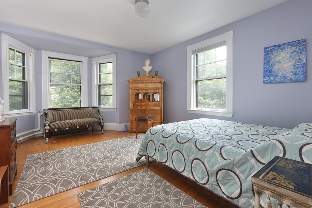 33 Thorndike Street Brookline, MA 02446 - Photo 7 of 13 a bedroom with a bed and a window