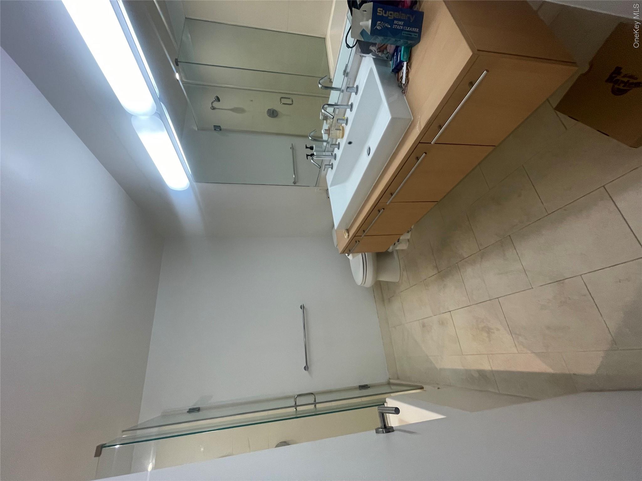 119 Fulton Street, Unit 5B Manhattan, NY 10038 - Photo 12 of 15 a bathroom with a sink mirror and toilet