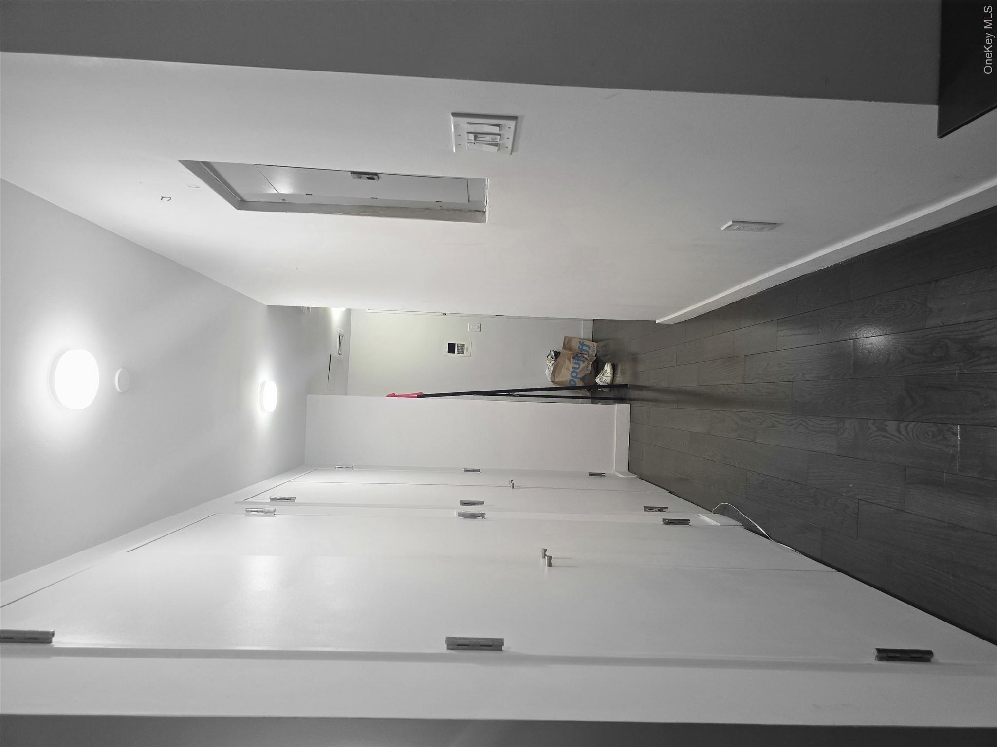 119 Fulton Street, Unit 5B Manhattan, NY 10038 - Photo 6 of 15 a view of hallway with a mirror