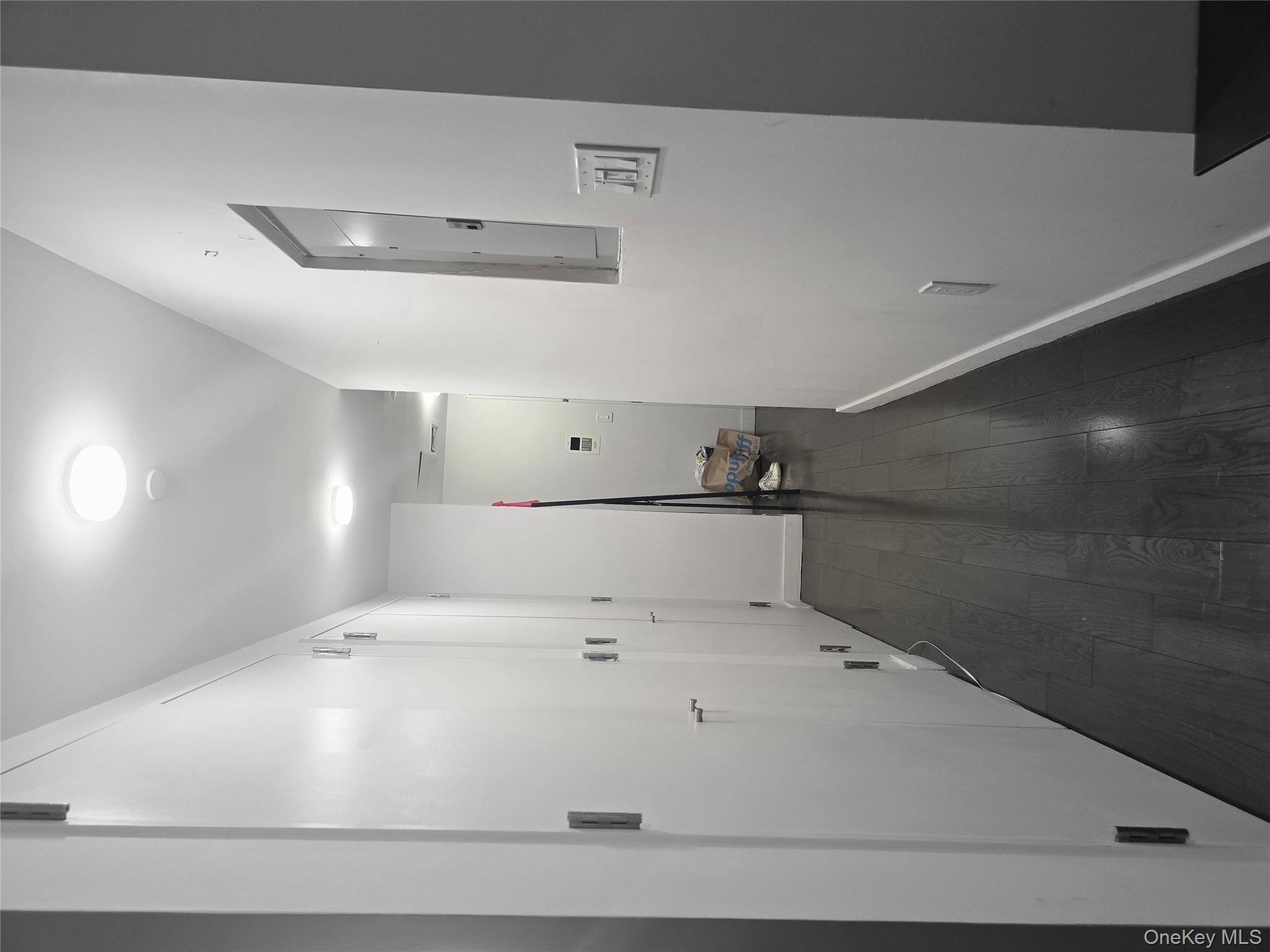 119 Fulton Street, Unit 5B Manhattan, NY 10038 - Photo 6 of 15 Hall featuring baseboards, electric panel, and dark wood finished floors