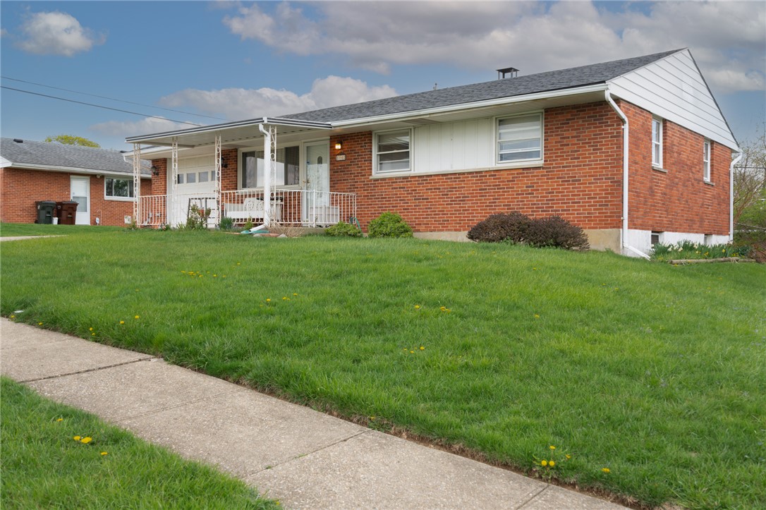 795 Spring Garden Place Dayton, OH 45431 - Photo 3 of 34 This classic brick residence features a welcoming covered porch, mature landscaping, and a well-maintained lawn.