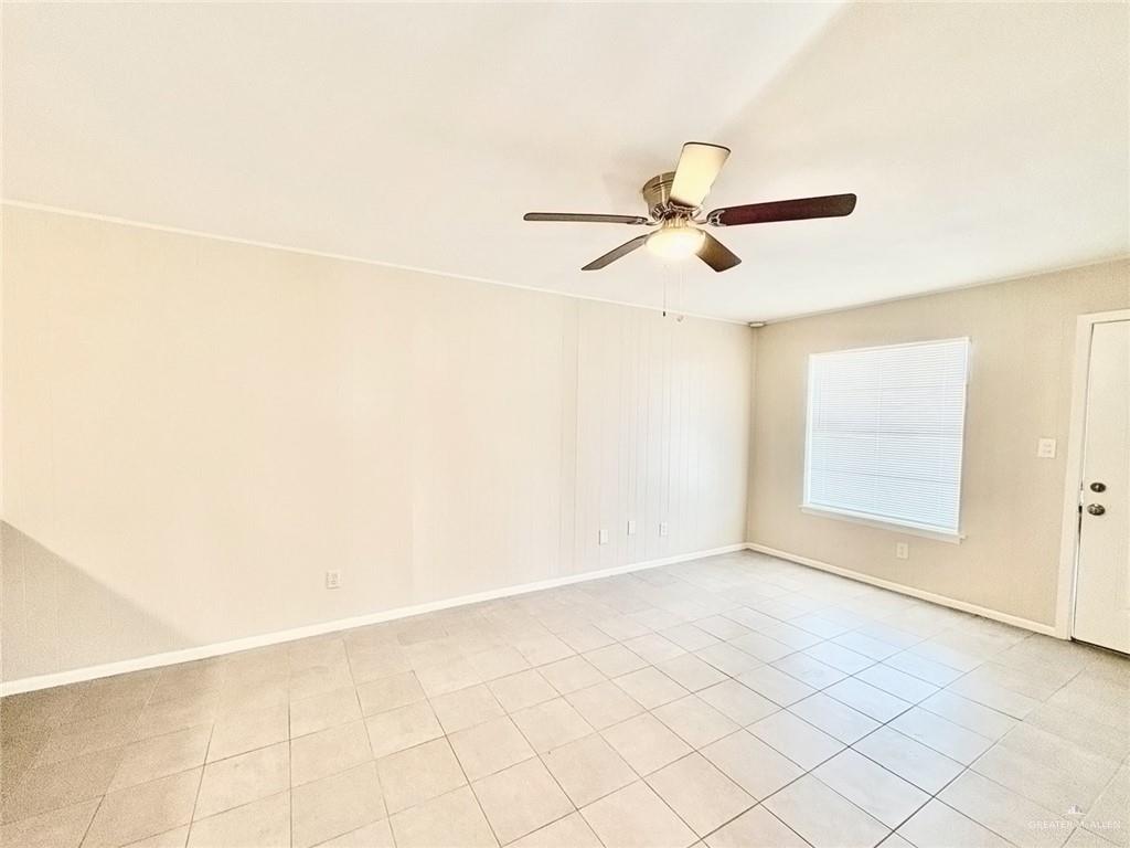 3616 Harvey Drive West, Unit 8 McAllen, TX 78501 - Photo 5 of 11 a view of a room with exposed radiator and ceiling fan