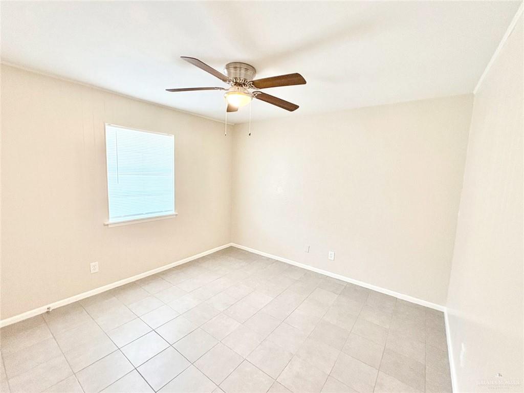 3616 Harvey Drive West, Unit 8 McAllen, TX 78501 - Photo 7 of 11 an empty room with a window and a fan