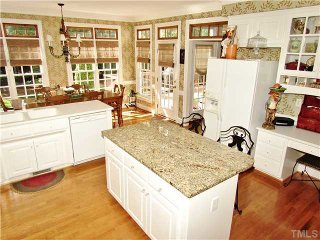 501 Chatterson Drive Raleigh, NC 27615 - Photo 8 of 25 a kitchen with granite countertop a sink and a stove top oven