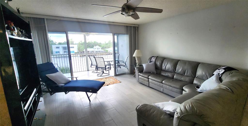 299 North Riverside Drive, Unit 303 Pompano Beach, FL 33062 - Photo 11 of 40 a living room with furniture and a large window