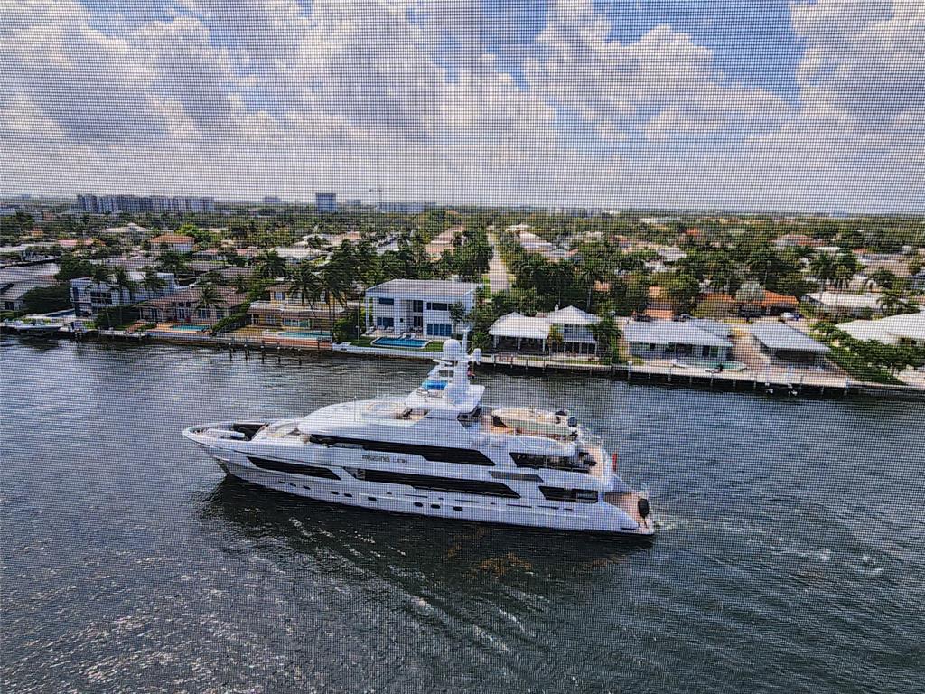 299 North Riverside Drive, Unit 303 Pompano Beach, FL 33062 - Photo 18 of 40 a view of a lake with boats and trees in the background