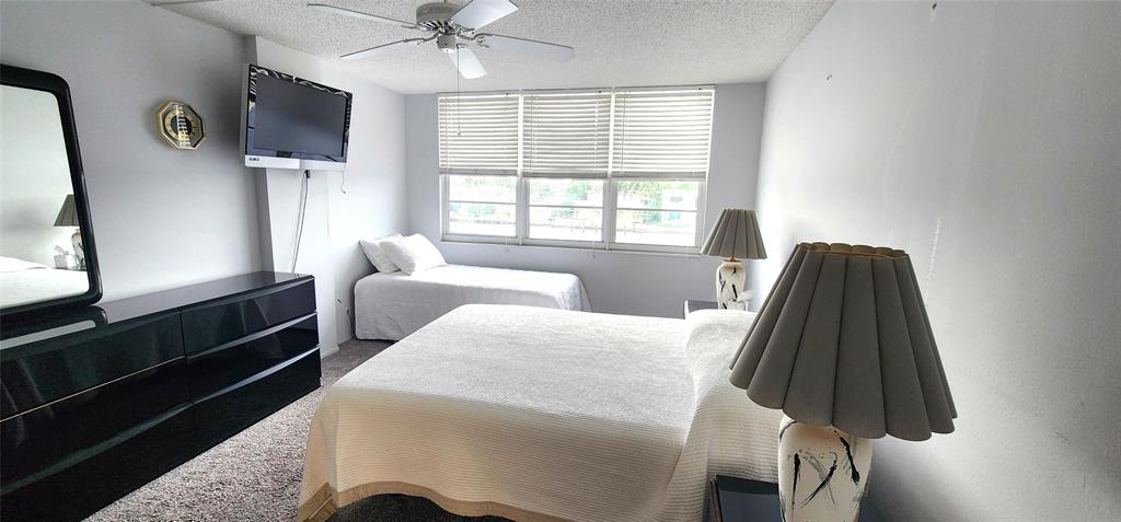 299 North Riverside Drive, Unit 303 Pompano Beach, FL 33062 - Photo 20 of 40 a bed room with a bed and a window