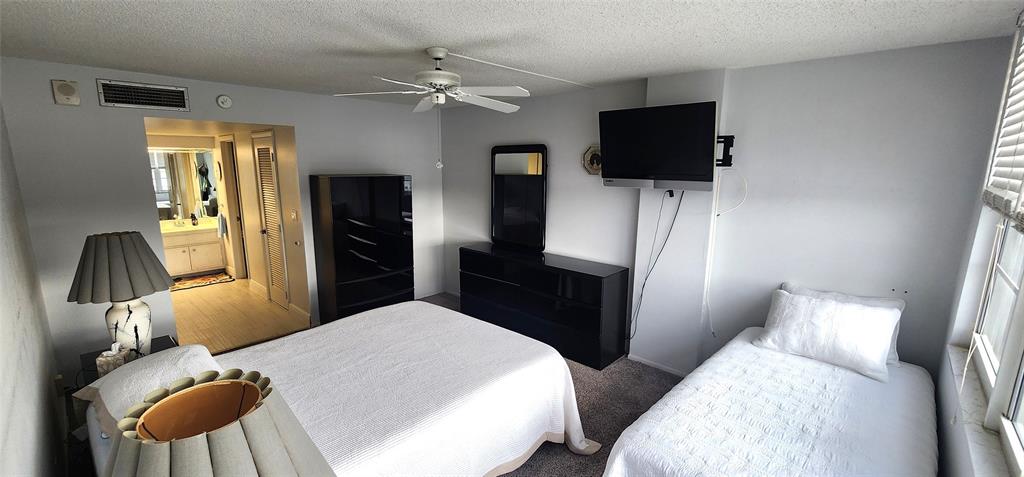 299 North Riverside Drive, Unit 303 Pompano Beach, FL 33062 - Photo 21 of 40 a bedroom with two bed and tv