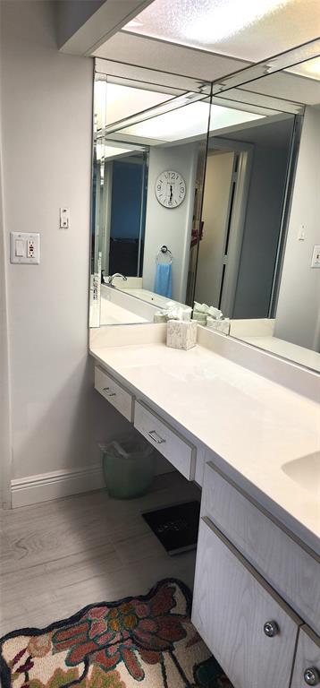299 North Riverside Drive, Unit 303 Pompano Beach, FL 33062 - Photo 23 of 40 a bathroom with a sink and a mirror