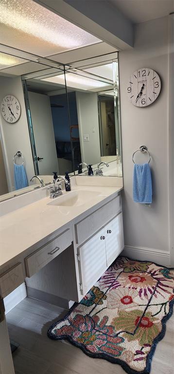 299 North Riverside Drive, Unit 303 Pompano Beach, FL 33062 - Photo 24 of 40 a bathroom with a sink a vanity and mirror
