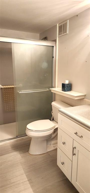 299 North Riverside Drive, Unit 303 Pompano Beach, FL 33062 - Photo 26 of 40 a white toilet sitting next to a bathroom sink