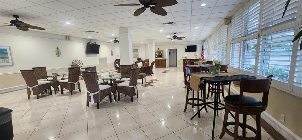 299 North Riverside Drive, Unit 303 Pompano Beach, FL 33062 - Photo 28 of 40 a view of a dining room and hall with furniture and a potted plant
