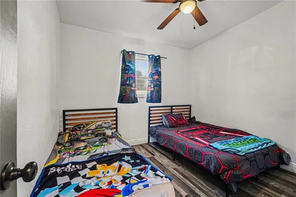a bedroom with bed and a chandelier