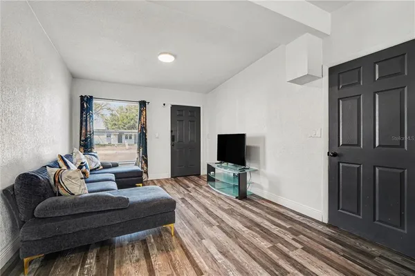 a living room with furniture and a flat screen tv