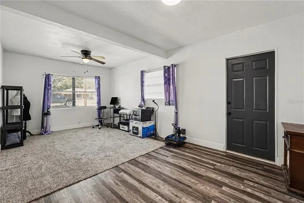 a view of a livingroom with workspace and a window