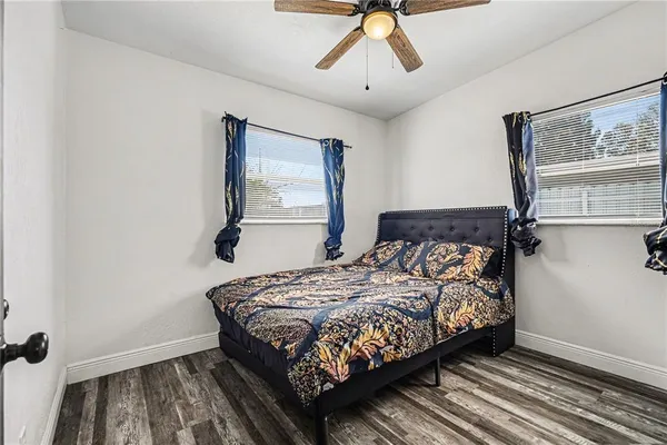 a bedroom with a bed and wooden floor