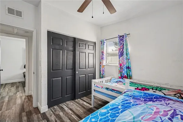 a bedroom with a bed and a dresser